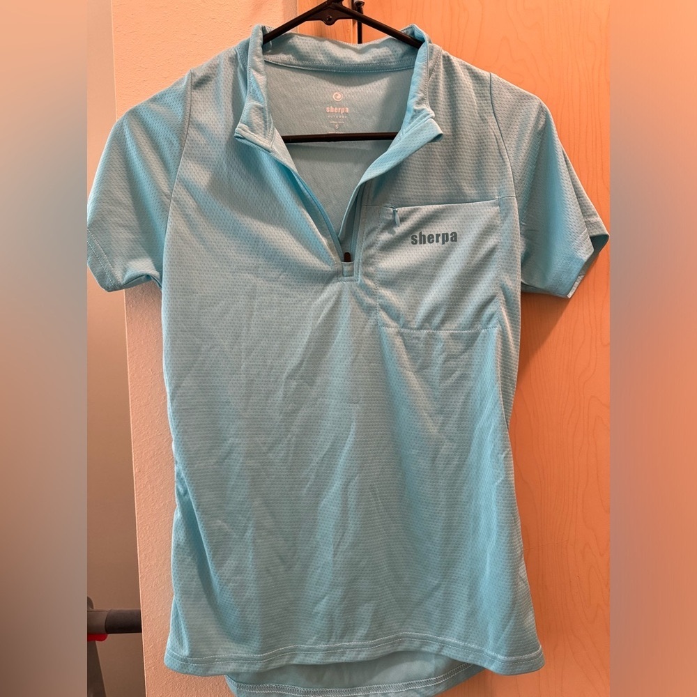 Sherpa brand. Light blue short sleeve top. Only work once.